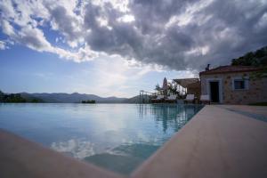 a swimming pool with a view of the water at Astrali Stone Villas in Paramythia