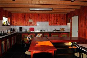 a kitchen with a wooden table and a counter top at Yourte Roulotte et Gite de la Laïta in Clohars-Carnoët