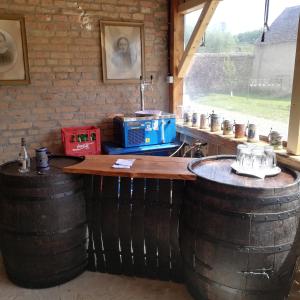 a kitchen with two large barrels and a counter at Casa din Barcut in Bărcuţ