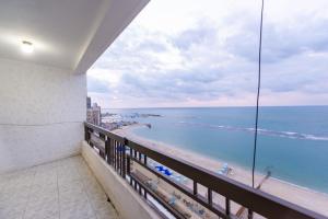 a balcony with a view of the ocean at ZAFERO POREFAG- Families only in Alexandria