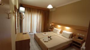 A bed or beds in a room at THEMIS BEACH
