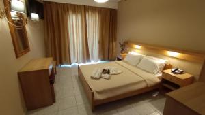 A bed or beds in a room at THEMIS BEACH