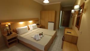 A bed or beds in a room at THEMIS BEACH