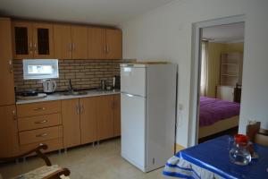 a kitchen with a white refrigerator in a room at House in Mestia in Mestia