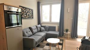 a living room with a couch and a tv at Rock-inn in Rokytnice nad Jizerou