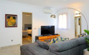 a living room with a couch and a flat screen tv at Villa Romaní in Sa Pobla