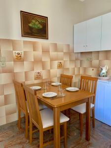 a kitchen with a wooden table with four chairs at Hygge Retreat in Preveza