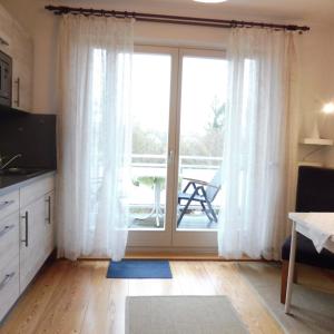 a living room with a sliding glass door at Doris` Hus in Travemünde