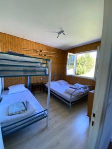 two bunk beds in a room with a window at Chalet Ascou-Pailhères in Ascou