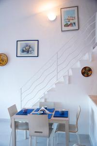 a dining room with a table and a staircase at Casa Valery Wonderful Sea View in Porto Rotondo