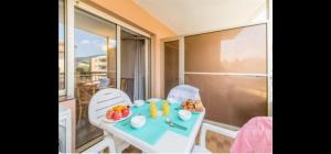 a table with a tray of fruit on a balcony at tecy les platanes in Sainte-Maxime