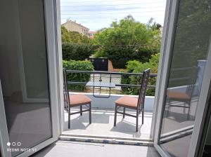 a balcony with two chairs and a table at Appartement Fréjus in Fréjus