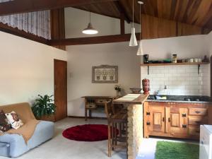 a kitchen with a couch and a table in a room at Loft Estrada Real in Petrópolis