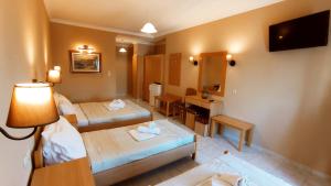 A bed or beds in a room at THEMIS BEACH