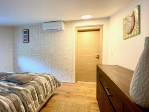 a bedroom with a bed and a dresser and a door at Apartments Pri nas in Kobarid