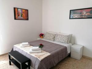 a small bedroom with a bed and a table at Giuseppe House in Pisa