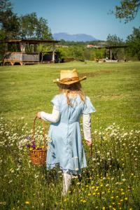 a girl in a field with a basket of flowers at Camping Freedom Istria Pitches in Foli