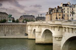 a bridge over a river in a city with buildings at ibis Styles Paris Opera Lafayette in Paris