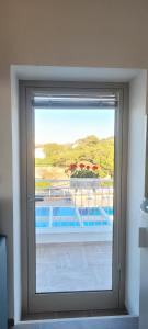 a window in a room with a view of a pool at Villaggio Camping Oasi in Vieste
