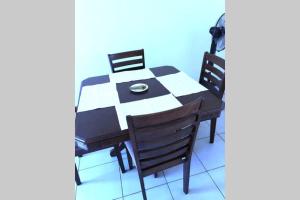 a table with two chairs and a plate on it at Kisumu 3 bedroom Apartment Elegant in Kisumu
