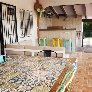 a table and chairs on a patio with a table andools at Chalet Cami de Merle in Denia