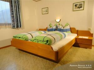 a bedroom with a bed with two pillows on it at Apartmenthaus Achenruh in Rauris