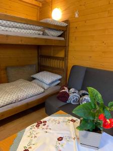 a room with two bunk beds and a table at Ranczo u Wilka z kominkiem in Chrzanów