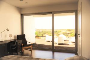 a bedroom with a sliding glass door leading to a patio at Spacious sunset Villa with breathtaking view in Portimão