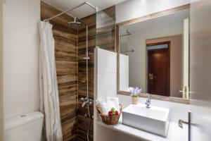 a bathroom with a sink and a mirror at Margarita Studios in Parikia