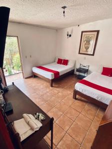 a room with two beds and a couch in it at Hotel De Cervantes in San Sebastián del Oeste +21 photos