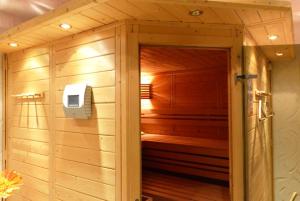 a wooden sauna with a door leading into a room at Hotel Prox in Arnstadt