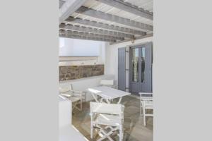 a dining room with a table and chairs at Infinity Blue in Kampos Paros