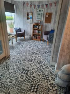 a living room with a patterned tile floor at Seals Bacton in Bacton