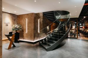 a large staircase leading up to a large room at DO & CO Hotel München in Munich