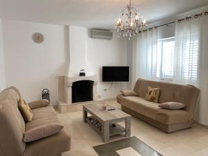 a living room with two couches and a tv at Villa Desiree in Prizba