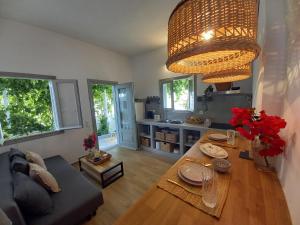 a living room with a couch and a table with flowers at Patmos Little Suites in Skala