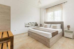 a white bedroom with a large bed and a window at New house in the village in Kráni