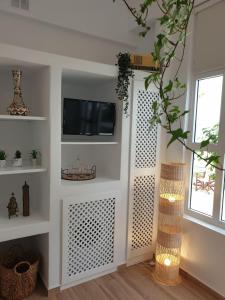 a living room with a tv on a wall at Patmos Little Suites in Skala