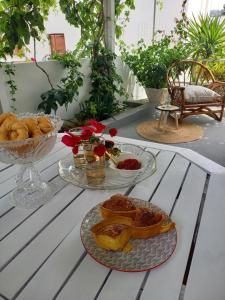 a table with two plates of food on it at Patmos Little Suites in Skala