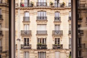 a facade of a building with balconies at Hôtel Maison Traversière in Paris