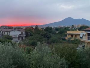 a sunset over a city with houses and a mountain at Hotel Due Pini Conte in Angri