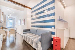 a living room with a blue and white striped wall at Blu Mare Apartment in Vernazza