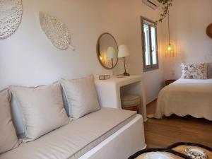 a living room with a couch and a bed at Patmos Little Suites in Skala