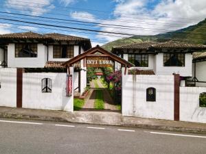 une maison avec un panneau indiquant le premier bail dans l'établissement Hostal Inti Luna, à Baños