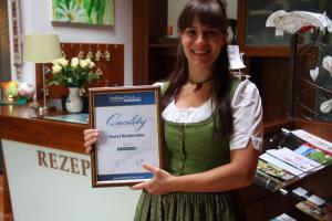 a girl is holding a sign in a store at Landhotel Waldmühle in Sankt Georgen im Attergau