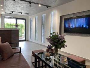 a living room with a tv on a wall at Vertoni Hotel Yerevan in Yerevan