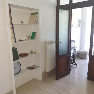una habitación con puerta y estanterías con reloj en vale countryhouse 10 minuti dal mare 10 minuti dalla montagna, en Ascoli Piceno