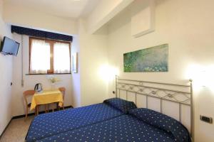 Postel nebo postele na pokoji v ubytování Albergo Al Carugio