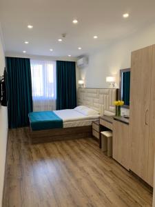 a bedroom with a large bed and a wooden floor at Vertoni Hotel Yerevan in Yerevan