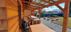 a wooden cabin with a porch and a patio at Chata BAŠKA na Liptove s vlastným dvorom in Liptovský Mikuláš